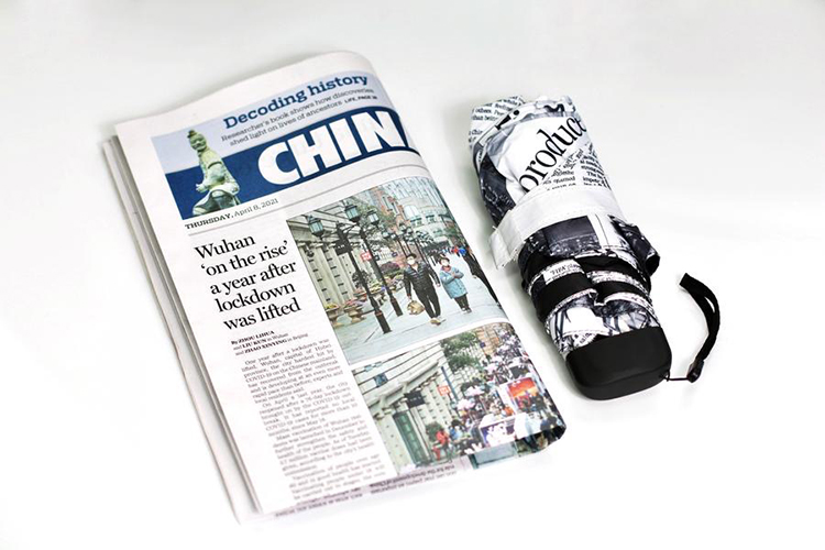 CHINA DAILY报纸与黑色马克杯文创周边产品展示
