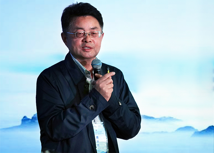 男性嘉宾手持话筒发表演讲,中国教育报校长大会现场