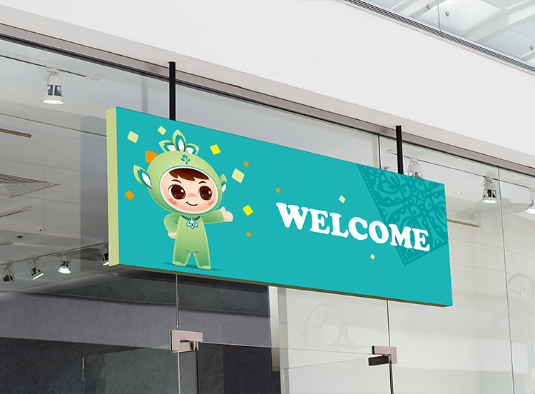 北医附小室内迎宾墙面导视设计,印有吉祥物形象与WELCOME英文欢迎语